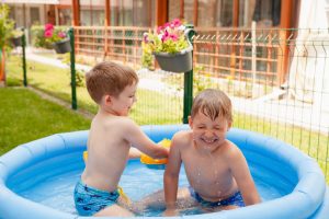 Two,children,with,toys,at,swimming,pool.,joyful,kid,playing