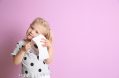 Cute,little,girl,holding,toilet,paper,roll,on,color,background.