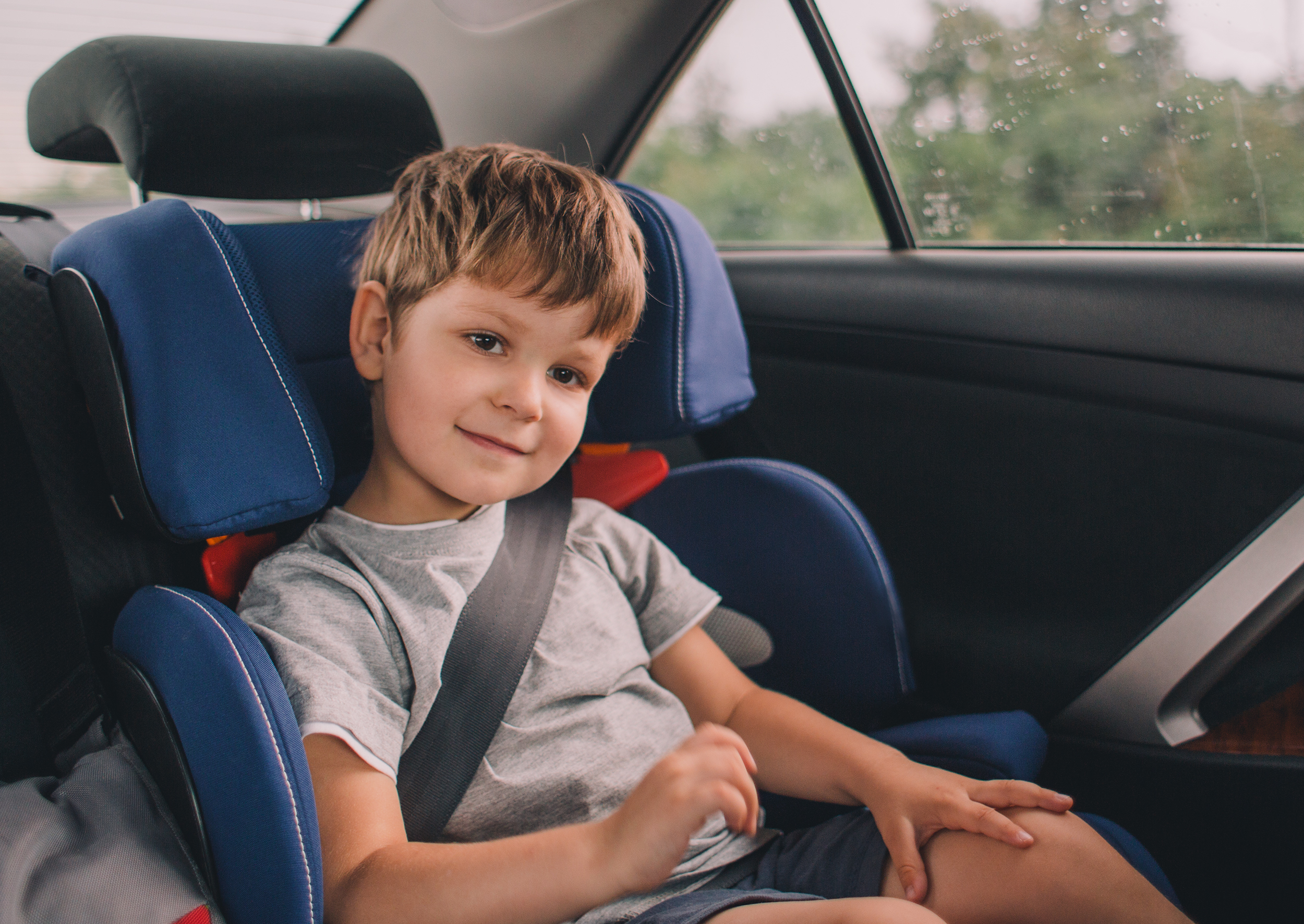 Little,boy,sitting,in,safety,car,seat