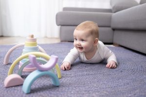 caucasian,newborn,3,months,old,trying,to,crawl.,joyfully,looks