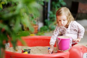 adorable,little,girl,playing,in,a,sandbox