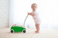 cute,baby,with,toy,walker,indoors